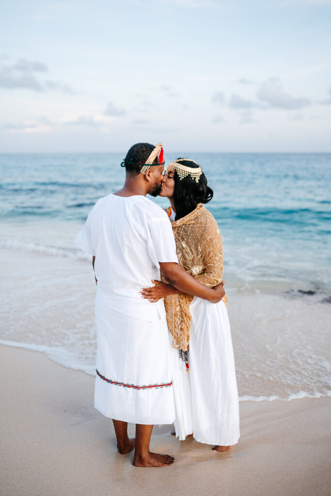 bride and groom kissing each other at Long Beach, St. Martin